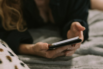 woman with cell phone in the room at home