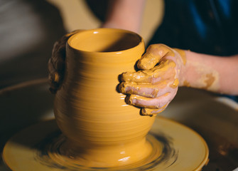 Pottery workshop. A little girl makes a vase of clay. Clay modeling