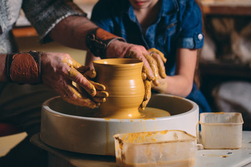 Pottery workshop. Grandpa teaches granddaughter pottery. Clay modeling