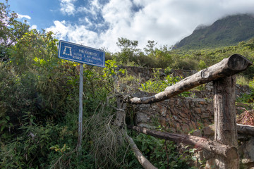 Pinchinuyok ancient Inca ruins surrounded by mountain peaks and clouds above the green canyon in Peru