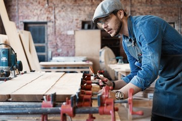 Successful handsome businessman with stylish cap work in carpentry