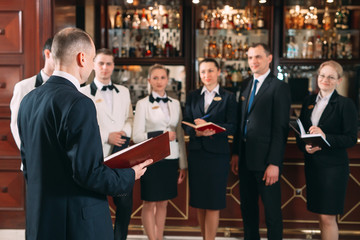 The interaction of the staff. Hotel or restaurant manager and his staff in kitchen. interacting to...
