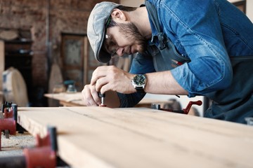 Fototapeta premium Successful handsome businessman with stylish cap work in carpentry