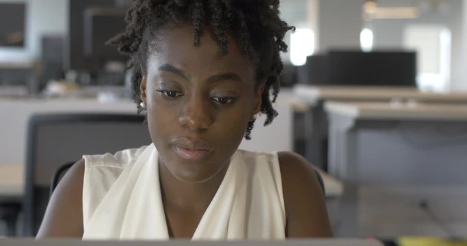 Young Woman Reads Email in Office Close Up