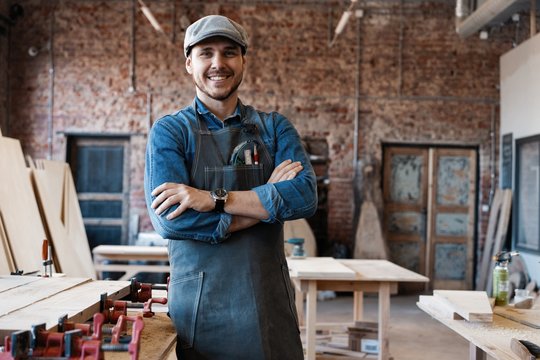 Successful handsome businessman with stylish cap work in carpentry