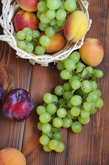 Ripe fresh Summer fruits on the wooden table