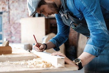 Successful handsome businessman with stylish cap work in carpentry