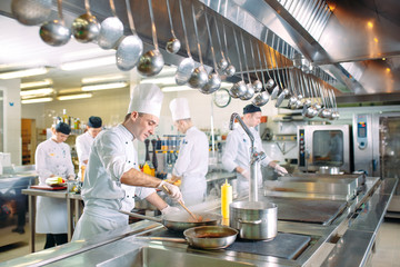 Modern kitchen. The chefs prepare meals in the restaurant's kitchen.