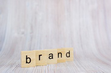 Wooden cubes with word brand on wooden table. Brand building for success concept