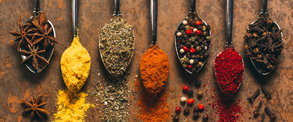 The Different Spices. Spices on stone background.