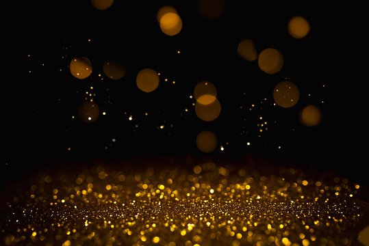 Golden abstract bokeh on black background. Holiday concept