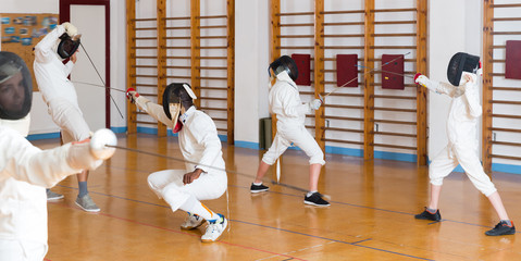 Friendly group  practicing fencing techniques