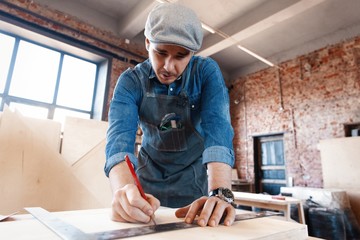 Successful handsome businessman with stylish cap work in carpentry