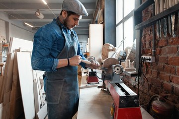 Successful handsome businessman with stylish cap work in carpentry