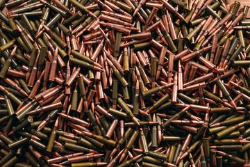 Different ammo on wooden background.