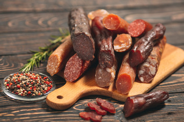 Different types of sausages and meat products on a wooden Board