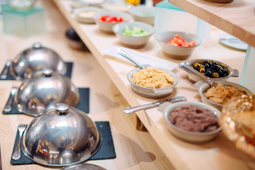 buffet in a restaurant or hotel. Metal dishes with caps.