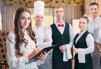 restaurant manager and his staff in kitchen. interacting to head chef in commercial kitchen.