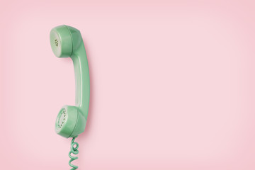 mint colored vintage phone receiver on a pink background, retro background, copyspace for your text - 280944195