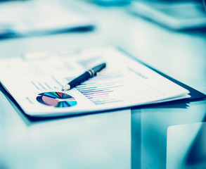 pen and financial documents on the table of the businessman