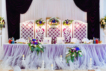 wedding table for the newlyweds in the hall of the restaurant. b