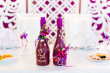 A close-up of two bottles of champagne on the wedding table. ins