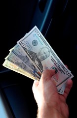 Hand transmitter dollars. Transferring money out of the hands. American dollars in a hand