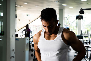 Fototapeta na wymiar Fit man standing and relax after the training session in gym,Concept healthy and lifestyle,Male taking a break after exercise and workout