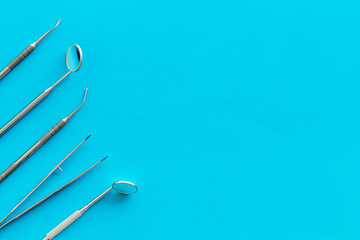 dentist desk with instruments on blue background top view mockup
