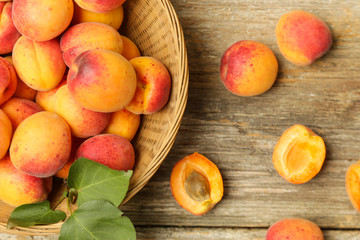 Top view of freshly harvested apricots in the bowl on the table	