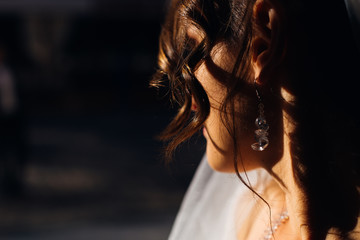 close-up curly hair of bride. the sunlight shines on the bride.