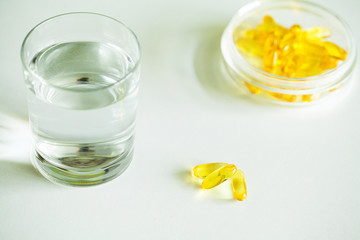 Vitamins supplements, fish oil in yellow capsules omega 3.