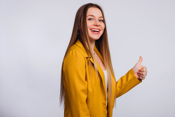 elegant girl with freckles and long hair shows a gesture and loo