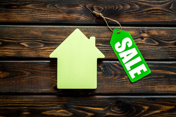 Discounts for house with sale lable on wooden background top view