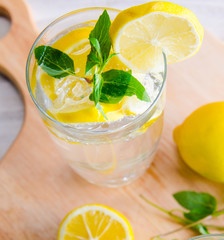 Glasss of mojito with lemon and drinking straw