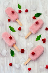 Strawberry and raspberry ice cream popsicles on white background