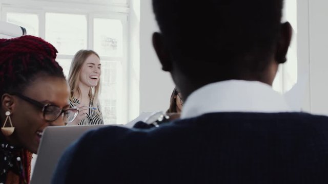 Young confident blonde business woman leader speaking to happy partners at modern office meeting slow motion RED EPIC.