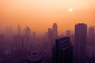 Air pollution covering Jakarta city at sunset