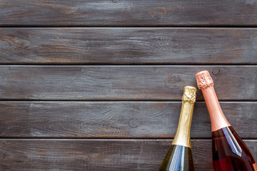 Party concept with champagne bottle on wooden background top view copyspace