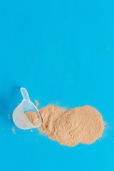 protein powder for fitness nutrition on blue background top view mock-up
