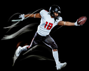 Plakat one african american football player man studio shot isolated on black background with light painting with blurred motion speed effect