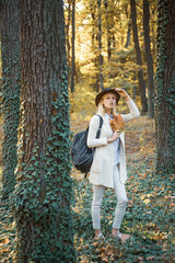 Cheerful carefree autumn woman in park on sunny day. Fall concept. Surprise autumn woman. Autumn girl preparing for Autumn sale.