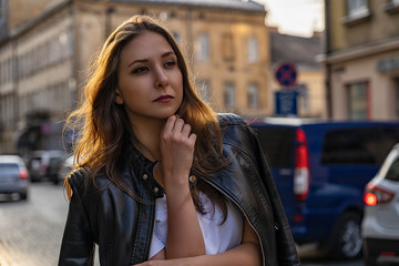 Fototapeta premium Portrait of the girl in black leather jacket on the street of Lviv city