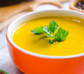 Pumpkin soup served on the table in bowl