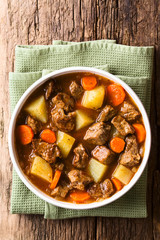 Fresh homemade beef stew with carrot and potatoes served in bowl, photographed overhead