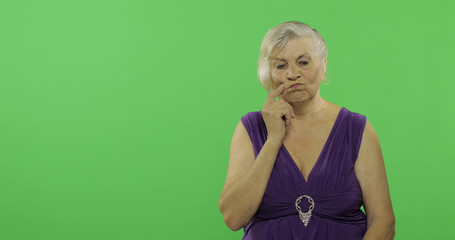 An elderly woman thinks about something. Old thoughtful grandmother. Chroma key