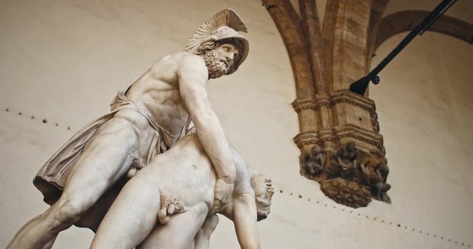 Looking and admiring beautiful italian roman sculpture. Low angle view of Patroclo e Menelao statue in Piazza della Signoria. Italian heritage. Tour around Florence, Tuscany.