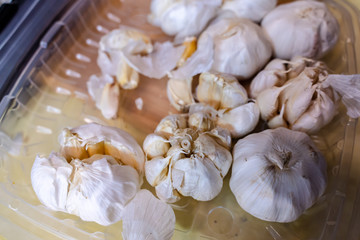 White garlic pile texture. Fresh garlic on market table closeup photo. Vitamin healthy food spice image. Spicy cooking ingredient picture. Pile of white garlic heads.
