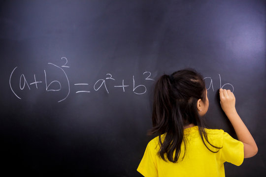 Female student writes mathematical equations - Powered by Adobe