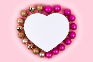 Christmas pink and gold balls with gift box on pink background. Christmas gifts and decoration on white background with copy space for text. 